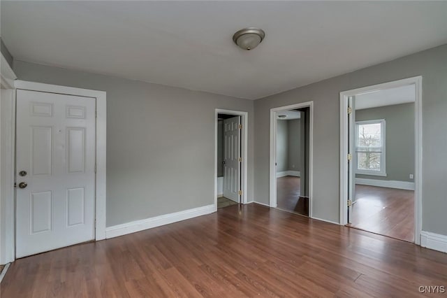 unfurnished room featuring dark hardwood / wood-style flooring