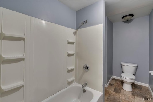 bathroom featuring toilet and bathing tub / shower combination