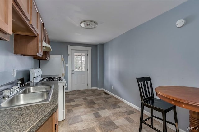 kitchen featuring white gas range and sink