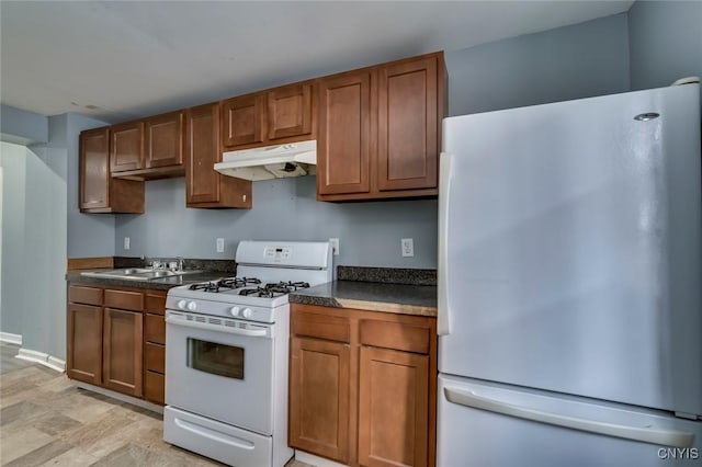 kitchen featuring stainless steel refrigerator, gas range gas stove, and sink