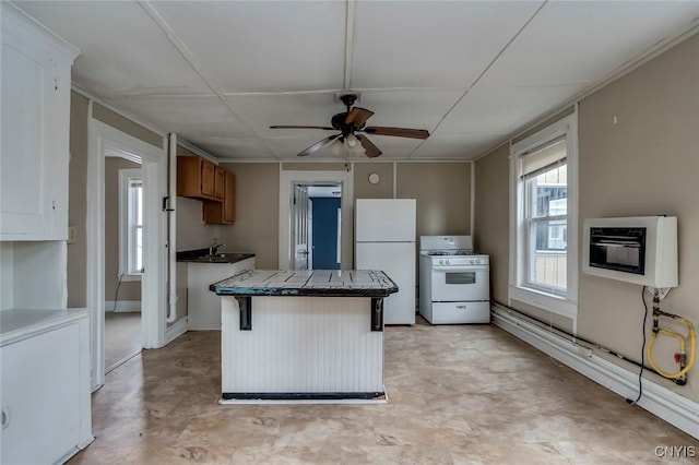 kitchen featuring ceiling fan, tile countertops, heating unit, white appliances, and a breakfast bar