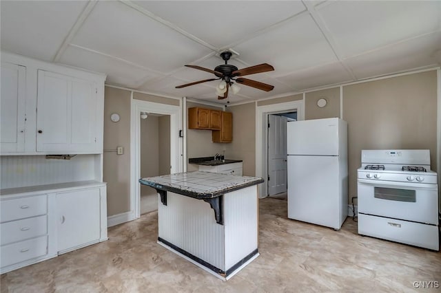 kitchen with tile countertops, ceiling fan, white cabinetry, and white appliances