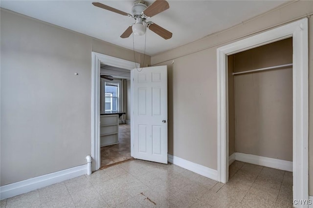 unfurnished bedroom with ceiling fan and a closet