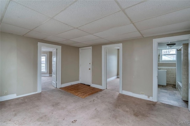 unfurnished room with a drop ceiling and light carpet