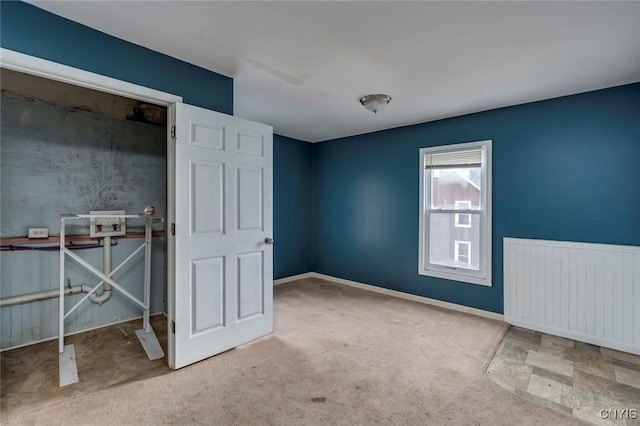 interior space featuring light carpet and radiator