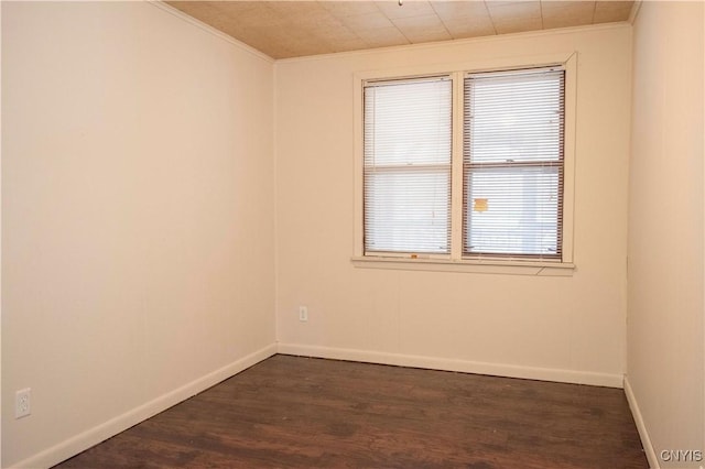 unfurnished room featuring dark hardwood / wood-style flooring and ornamental molding