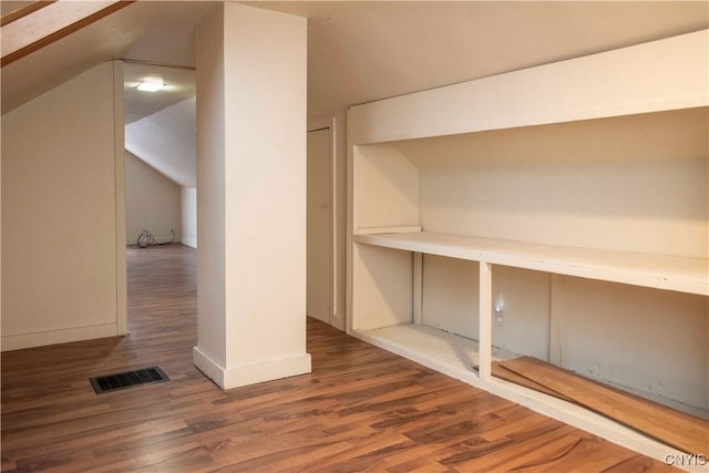 additional living space featuring wood-type flooring and lofted ceiling