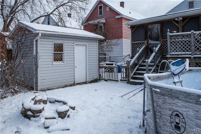 exterior space with a deck and an outdoor fire pit