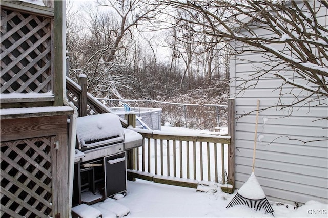 snow covered deck featuring a grill