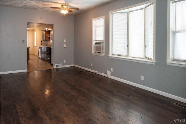 spare room featuring dark hardwood / wood-style flooring and ceiling fan