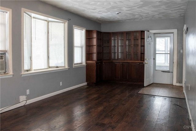 foyer entrance featuring a healthy amount of sunlight and dark wood-type flooring