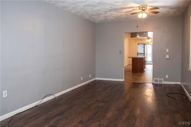 spare room featuring dark wood-type flooring