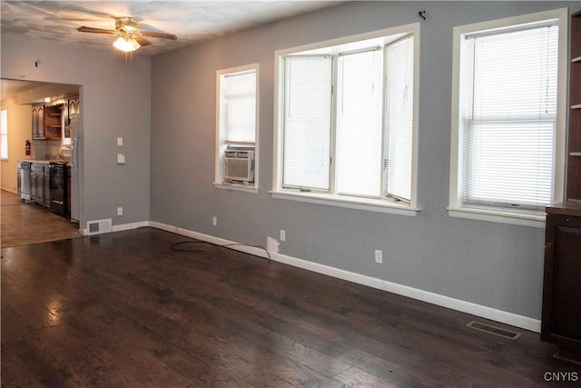 interior space featuring ceiling fan, cooling unit, and dark wood-type flooring