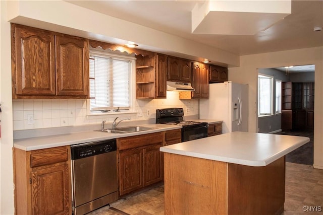 kitchen featuring dishwasher, black range with electric cooktop, white refrigerator with ice dispenser, and a kitchen island