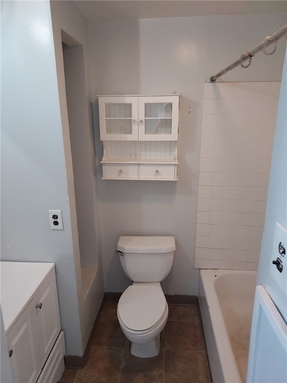 full bathroom with vanity, tiled shower / bath, tile patterned floors, and toilet