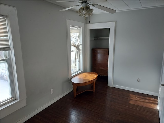 unfurnished bedroom with dark hardwood / wood-style floors, ceiling fan, and a closet