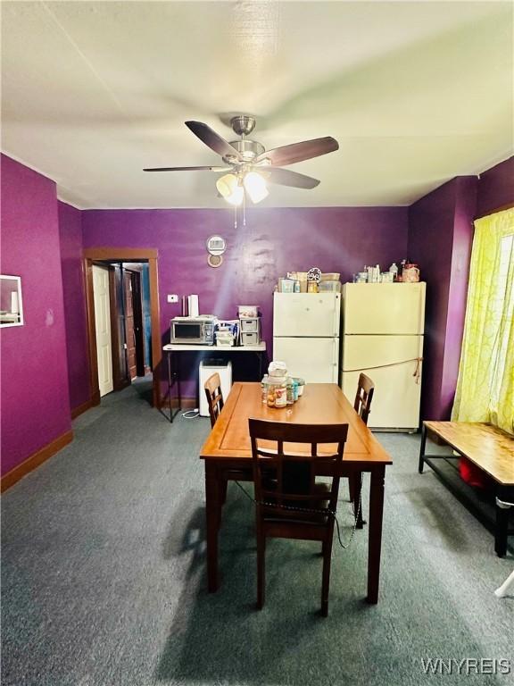 dining area with carpet floors and ceiling fan