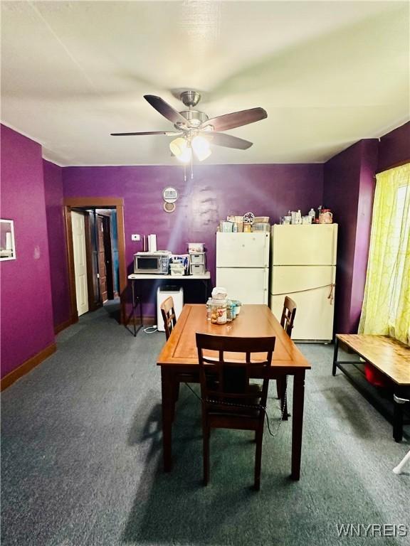 dining area featuring ceiling fan and carpet floors