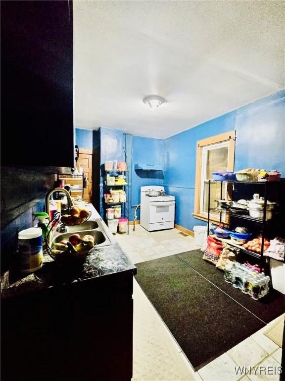 interior space with a textured ceiling and sink