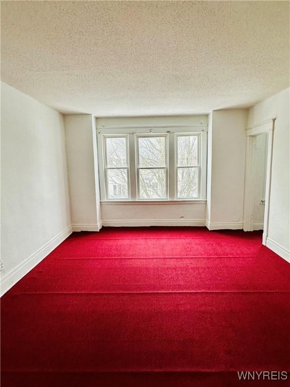 unfurnished room featuring a textured ceiling