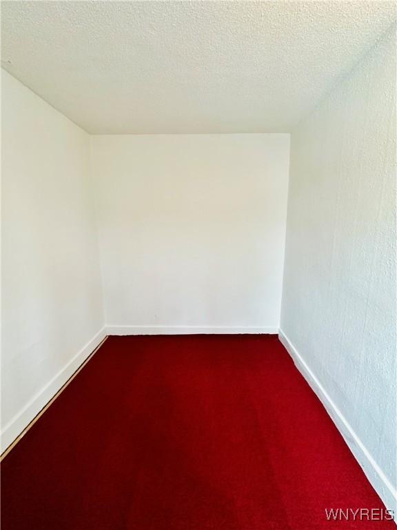 empty room featuring a textured ceiling