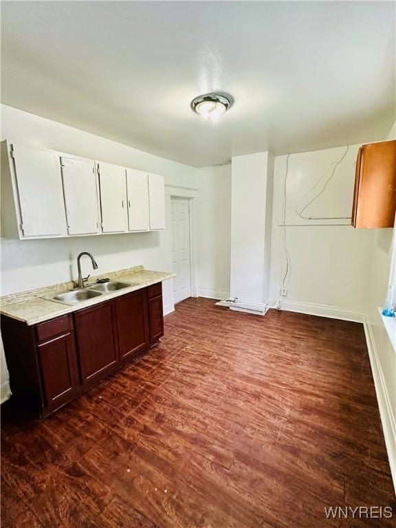 kitchen with white cabinets, dark brown cabinets, dark hardwood / wood-style flooring, and sink