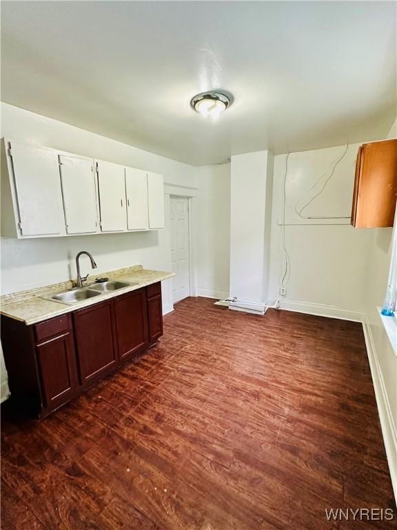 kitchen with white cabinets, dark brown cabinets, dark hardwood / wood-style floors, and sink