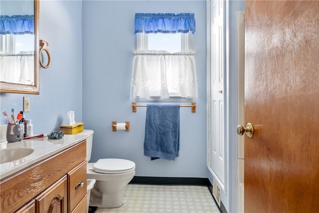 bathroom featuring vanity and toilet