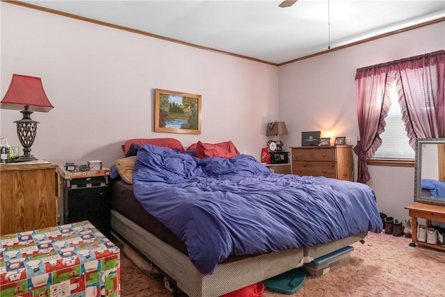 carpeted bedroom with ceiling fan and ornamental molding