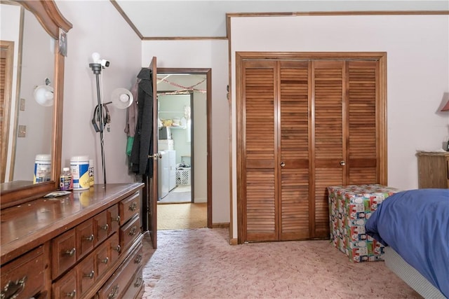 carpeted bedroom featuring crown molding and a closet