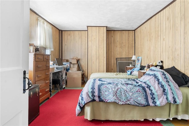 bedroom featuring a textured ceiling, crown molding, and wooden walls