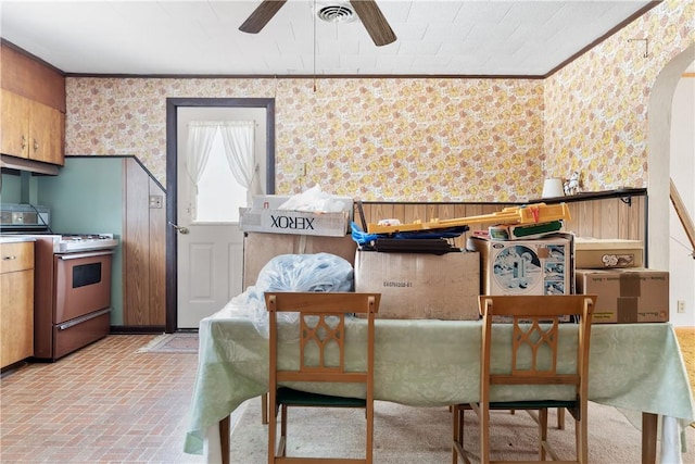 dining area featuring ceiling fan and crown molding