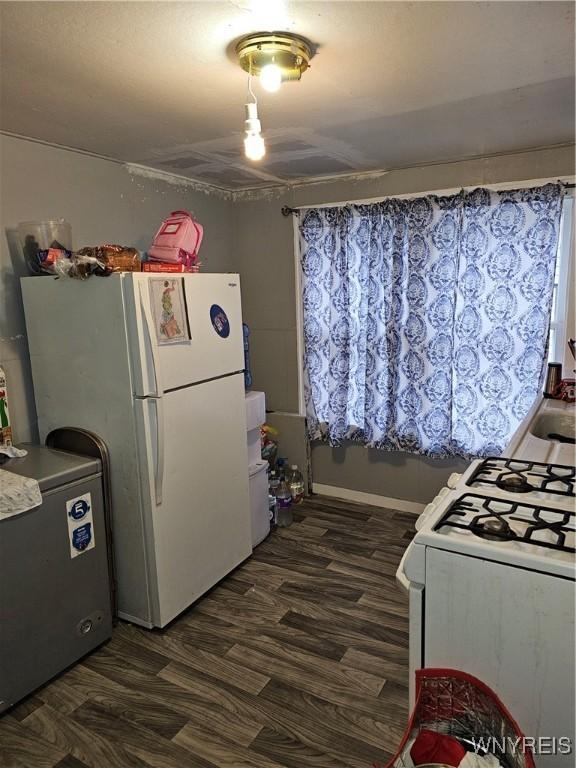 kitchen featuring white appliances and dark wood-type flooring