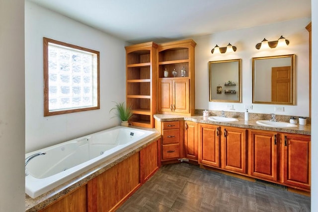 bathroom with vanity, parquet flooring, and a bath