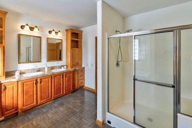 bathroom featuring vanity, parquet flooring, and a shower with shower door