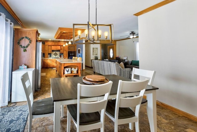 dining area with crown molding and ceiling fan with notable chandelier