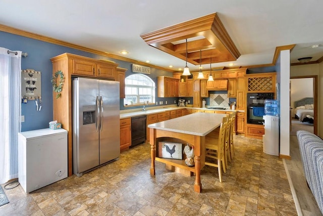 kitchen featuring tasteful backsplash, ornamental molding, black appliances, a kitchen island, and decorative light fixtures