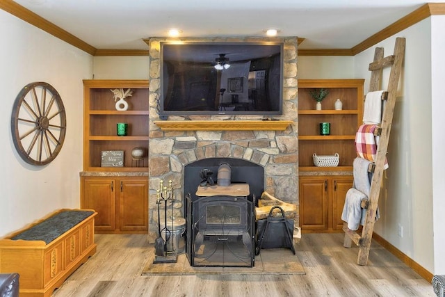 living room with light wood-type flooring, ornamental molding, and a wood stove