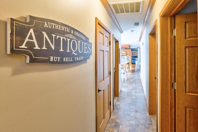 hallway featuring crown molding