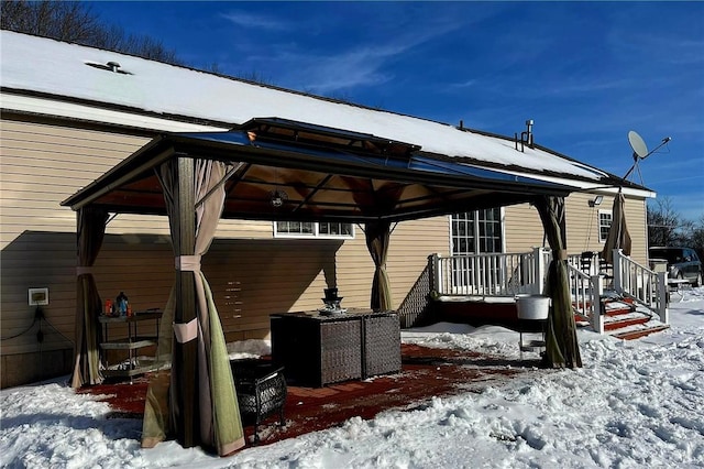 snow covered patio with a gazebo