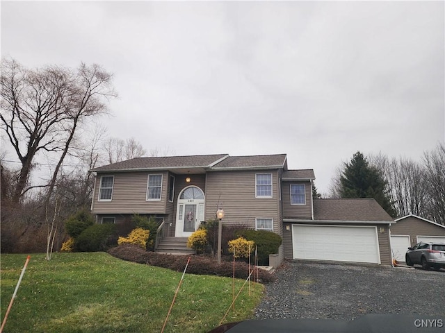 split foyer home featuring a front yard and a garage