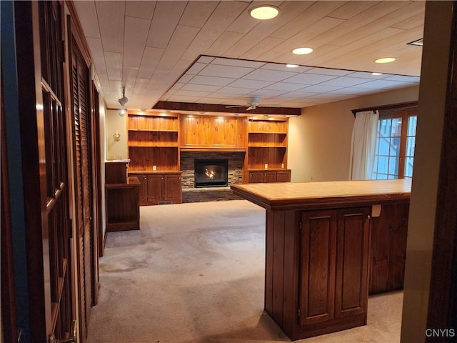 bar with light carpet and a stone fireplace