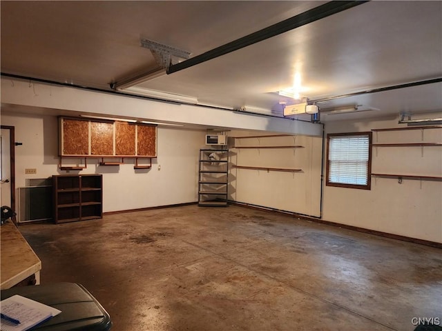 garage with baseboards and a garage door opener