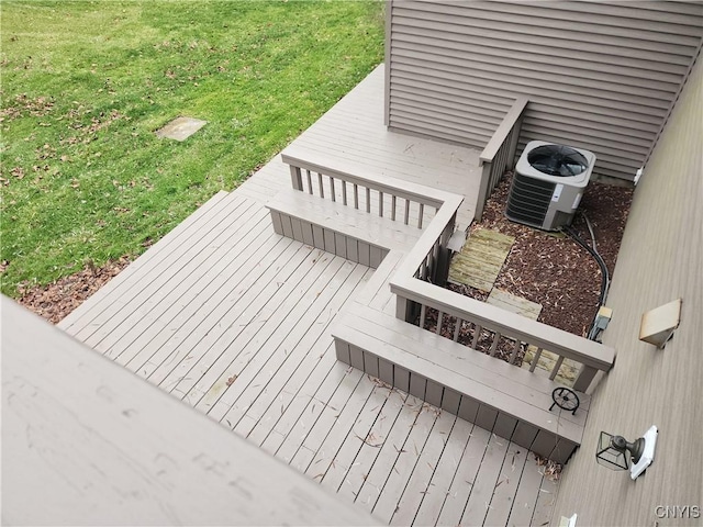 wooden deck with a yard and cooling unit