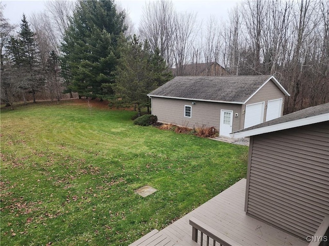 view of yard with a wooden deck, an outdoor structure, and a garage