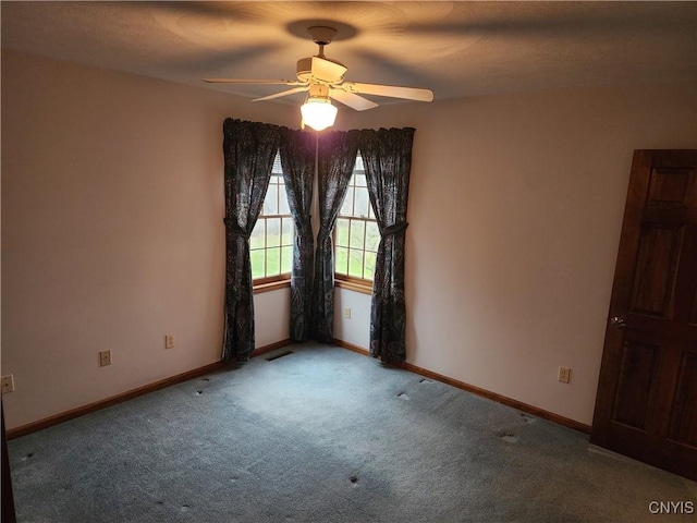 carpeted empty room featuring ceiling fan