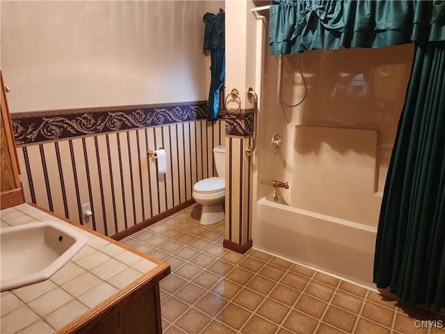 full bathroom with tile patterned flooring, toilet, shower / bathtub combination with curtain, and sink