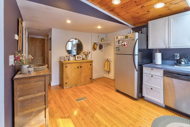 kitchen with lofted ceiling, visible vents, light wood-style flooring, appliances with stainless steel finishes, and white cabinets