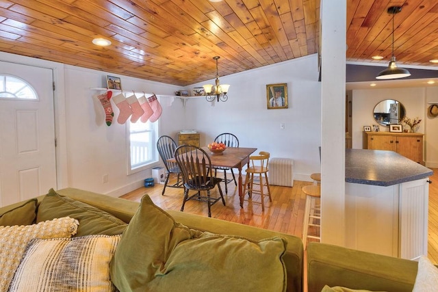 dining area with wooden ceiling, baseboards, vaulted ceiling, light wood-type flooring, and radiator heating unit