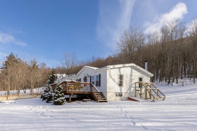 view of snow covered exterior featuring a deck